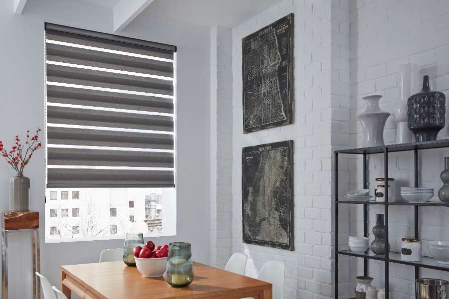A gray transitional shade on a dining room window